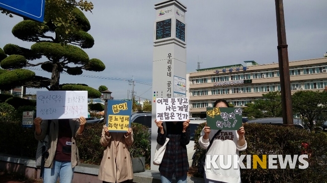 전북 익산시 주부들이 악취문제 해결을 촉구하고 있다. 뒤에는 익산시 공기 오염도를 알려주는 공기 알리미가 ‘좋음’을 표시하고 있다.